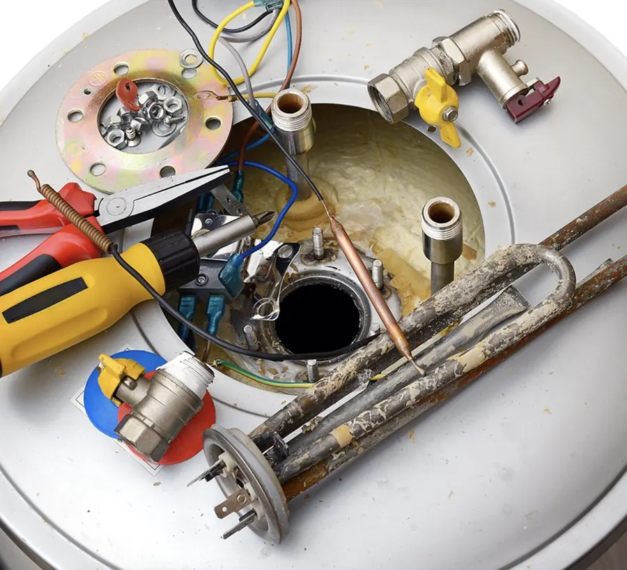 Water heater opened for service with the heating element, anode rod, relief valve and hand tools laid out &mdash; Foothills Water Heaters